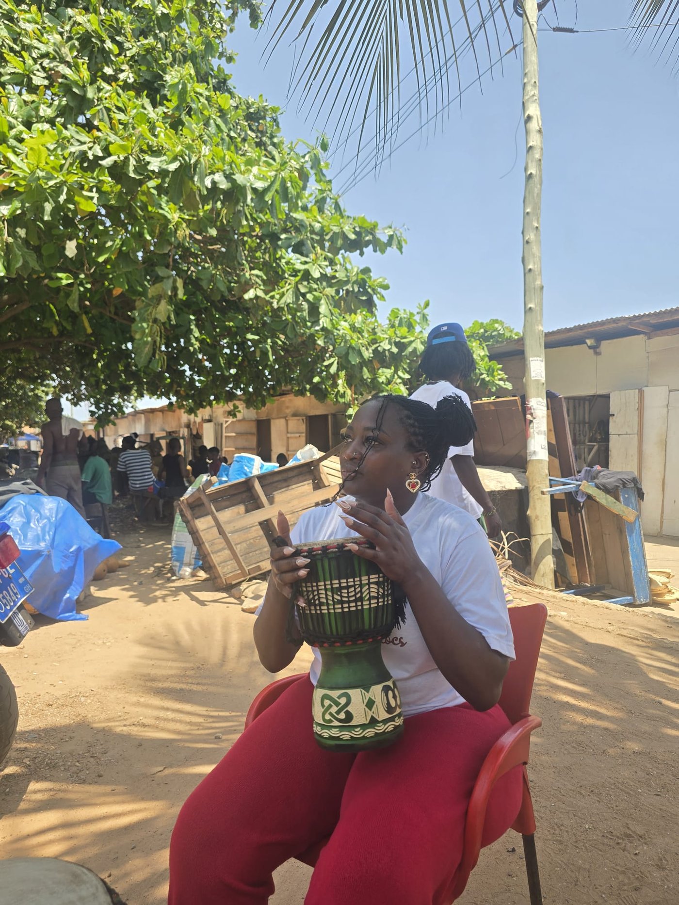 Loreta Waziri in Ghana, playing a djembe drum